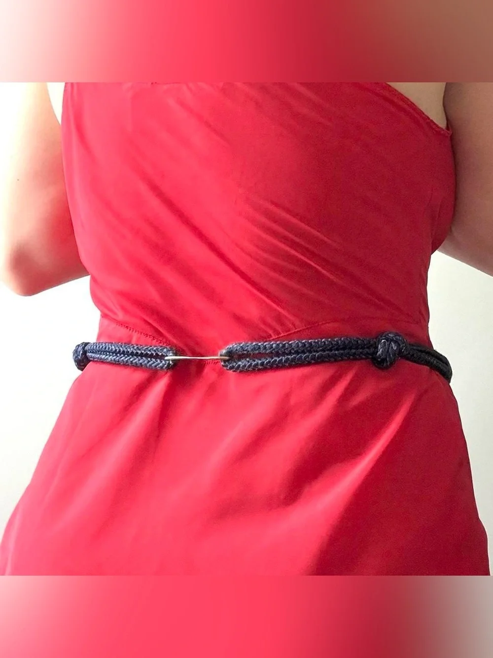 Multicoloured braided belt with decorative medallion